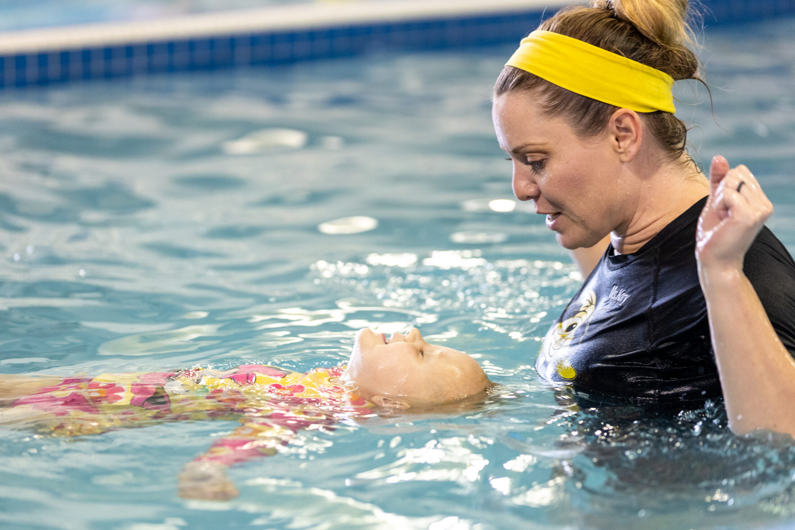 Ms. Kory Little Fins Colorado Springs teaching lifesaving swimming skills to a little girl learning to float