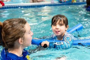 swim lessons at little fins swim school - child and instructor
