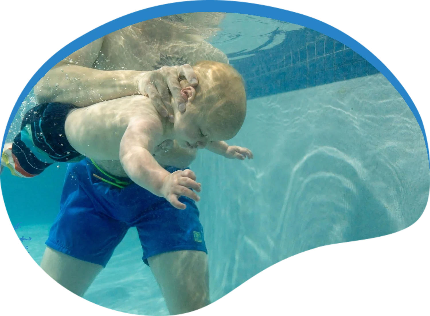 Baby swimming underwater during an Infant Survival swim lesson at Little Fins Swim School